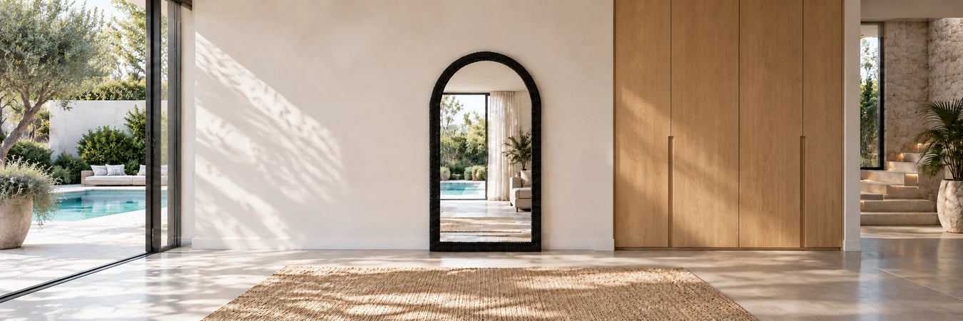 Ebon Arc Floor Mirror in a warmly styled coastal home
