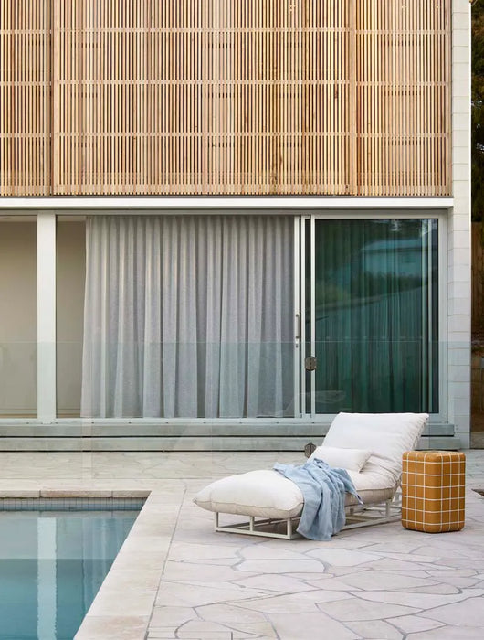 Seville Tiled Side Table in honey beside a white sun lounger on a poolside terrace