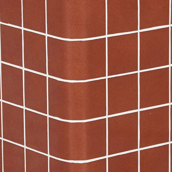 Close-up of red glaze tiles and white grout wrapping a corner of the Andalusian Mosaic Side Table
