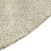 Tepih Dune Round Rug in Oatmeal, close-up of the curved edge and flecked weave