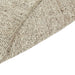Tepih Dune Round Rug in Oatmeal, close-up of the curved edge folded over, showing the flecked weave