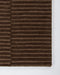 Anni Floor Rug in Chocolate, close-up of a corner showing the edge and wool pile