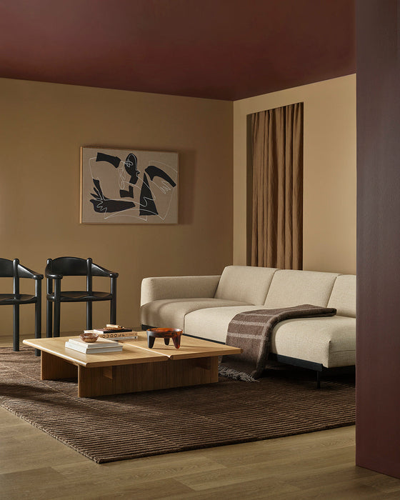Anni Floor Rug in Chocolate, styled in a living room with a cream sofa, low timber coffee table and dark chairs