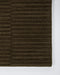 Anni Floor Rug in Mangrove, close-up of a corner showing the edge and wool pile