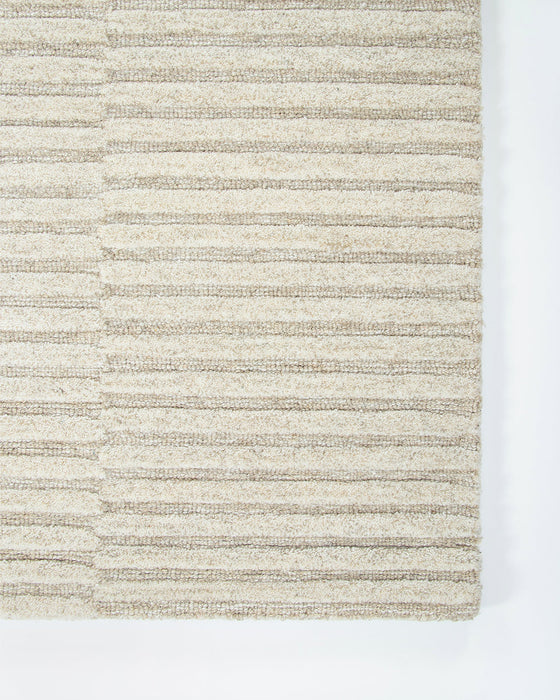 Anni Floor Rug in Oat, close-up of a corner showing the edge and wool pile