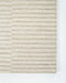 Anni Floor Rug in Oat, close-up of a corner showing the edge and wool pile