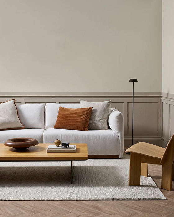 Clifton Floor Rug in Bone, styled in a panelled living room with a white sofa and timber coffee table