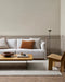 Clifton Floor Rug in Bone, styled in a panelled living room with a white sofa and timber coffee table