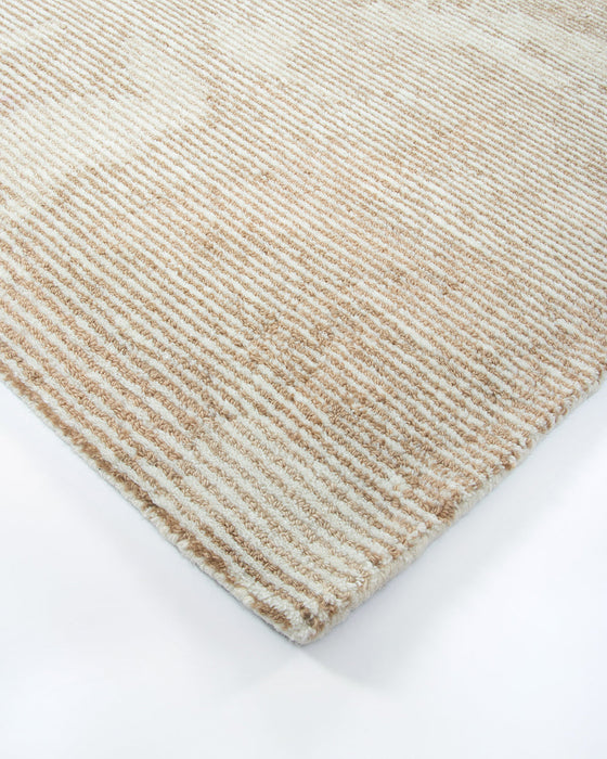 Beckett Floor Rug in Straw, close-up of a corner showing the edge and wool pile