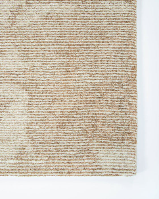 Beckett Floor Rug in Straw, close-up of a corner showing the edge and wool pile
