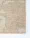 Beckett Floor Rug in Straw, close-up of a corner showing the edge and wool pile