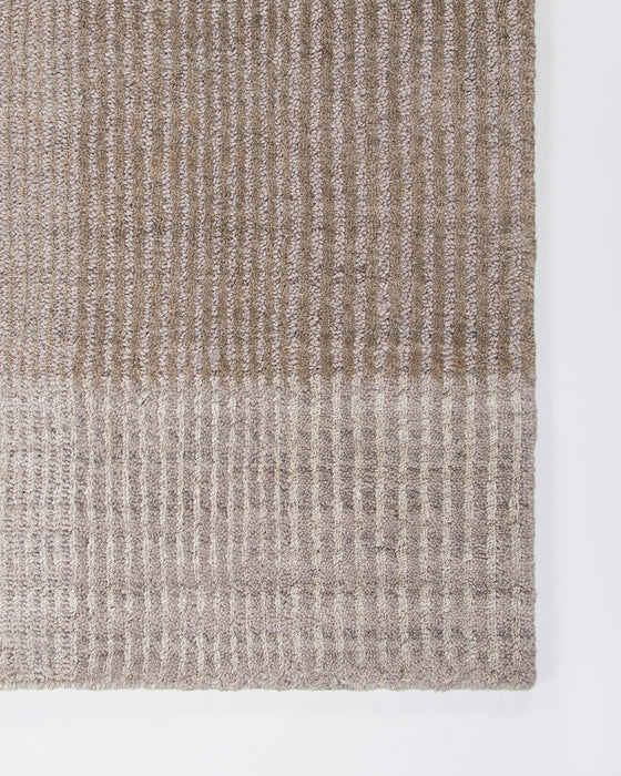 Bedrock Floor Rug in Sand, close-up of a corner showing the edge and recycled PET pile