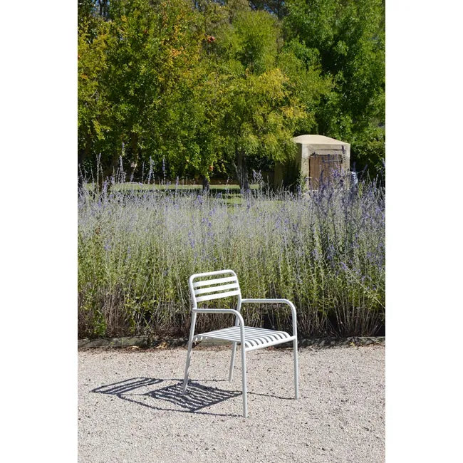 Dockside Wind Dining Chair in white on gravel in front of a lavender garden