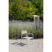 Dockside Wind Dining Chair in white on gravel in front of a lavender garden