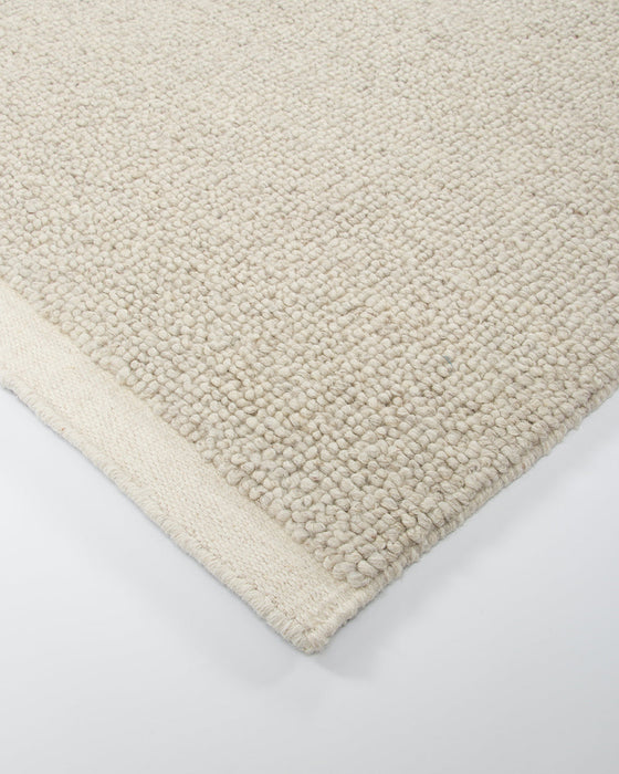 Clifton Floor Rug in Bone, close-up of a corner showing the edge and wool pile