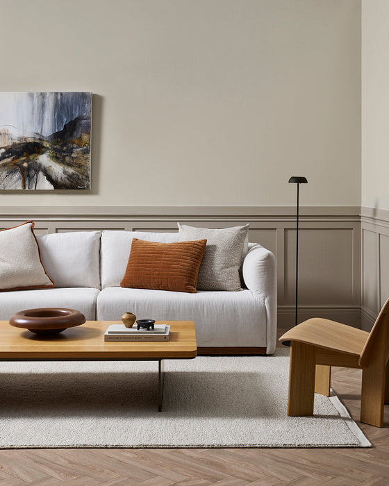 Clifton Floor Rug in Bone, under a timber coffee table and white sofa with artwork above