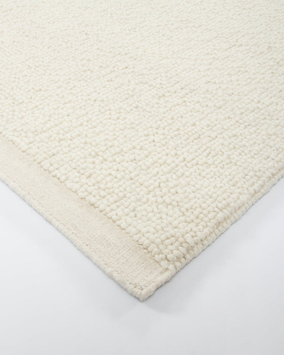 Clifton Floor Rug in Ivory, close-up of a corner showing the edge and wool pile