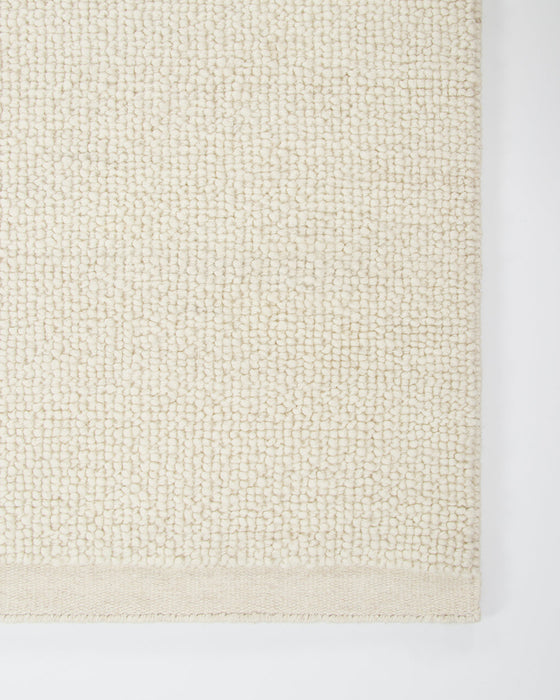 Clifton Floor Rug in Ivory, close-up of a corner showing the edge and wool pile