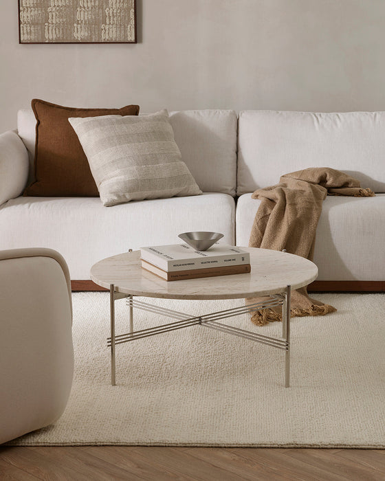 Clifton Floor Rug in Ivory, under a round stone coffee table beside a white sofa with cushions