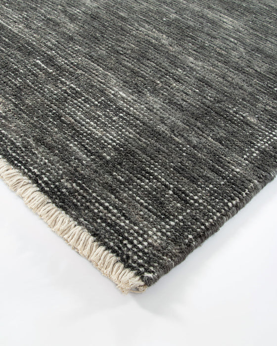 Corbett Floor Rug in Peat, close-up of a corner showing the edge and wool pile