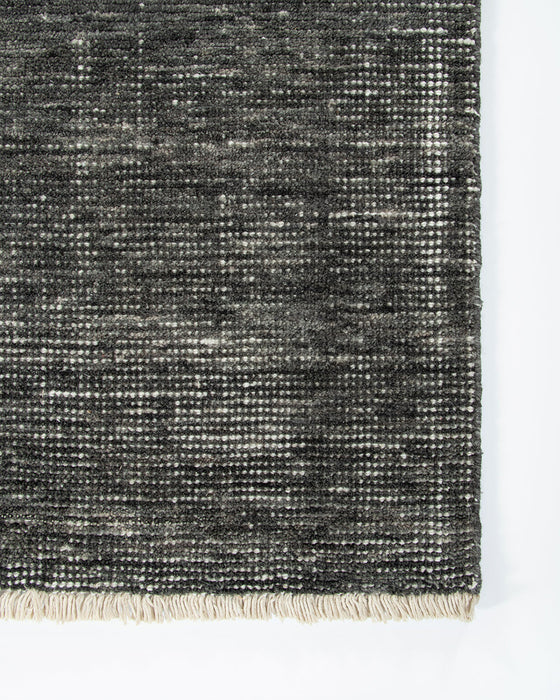 Corbett Floor Rug in Peat, close-up of a corner showing the edge and wool pile