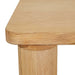 Close-up of the rounded oak tabletop corner above a round leg, Flint Dining Table