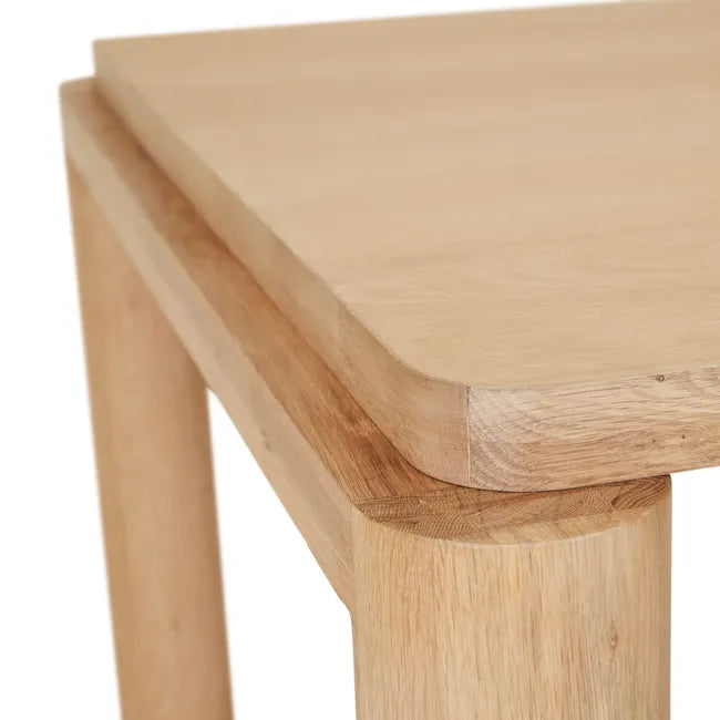 Close-up of the oak tabletop edge and leg of the Flint Dining Table