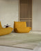 Edgewater Floor Rug in Pistachio, in a living room with mustard lounge chairs and timber slat screen