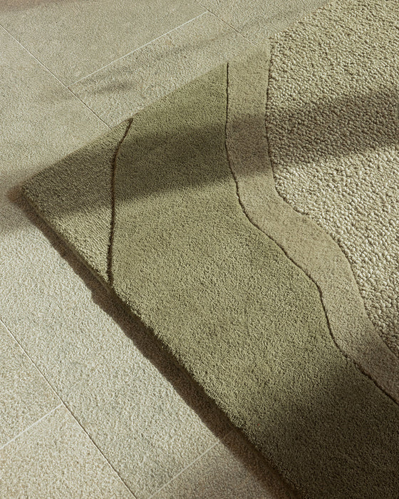 Edgewater Floor Rug in Pistachio, close up of the corner, showing the carved wave pattern