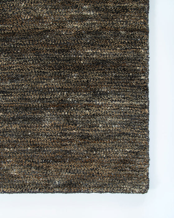 Fairbanks Floor Rug in Fossil, close-up of a corner showing the edge and viscose and jute pile