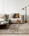 Fairbanks Floor Rug in Fossil, styled in a living room with a cream sofa and floor lamp