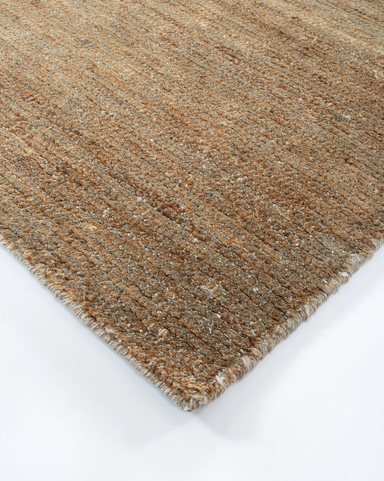 Fairbanks Floor Rug in Sand, close-up of a corner showing the edge and viscose and jute pile