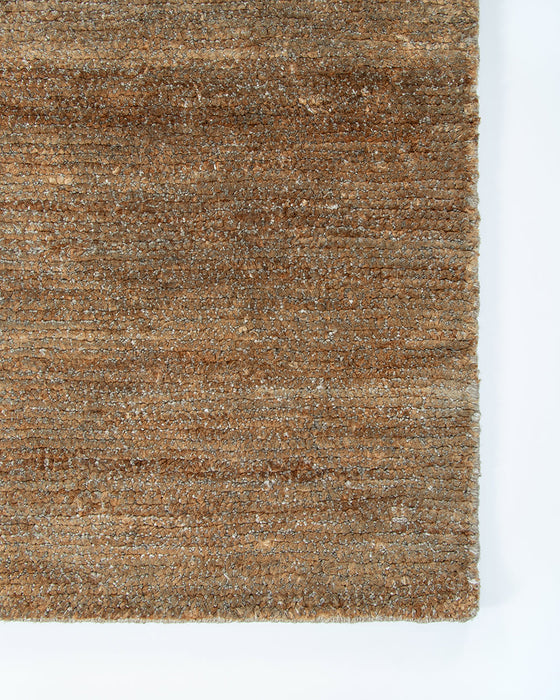 Fairbanks Floor Rug in Sand, close-up of a corner showing the edge and viscose and jute pile