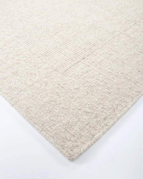 Vermont Floor Rug in Sand, close-up of a corner showing the edge and wool pile