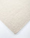 Vermont Floor Rug in Sand, close-up of a corner showing the edge and wool pile
