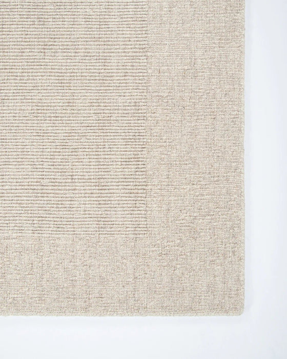 Vermont Floor Rug in Sand, close-up of a corner showing the edge and wool pile