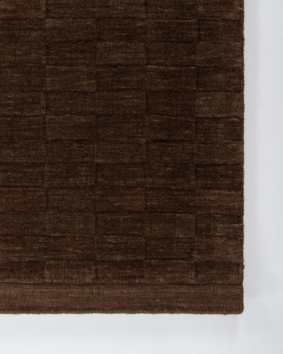 Hugo Floor Rug in Espresso, close-up of a corner showing the edge and wool pile