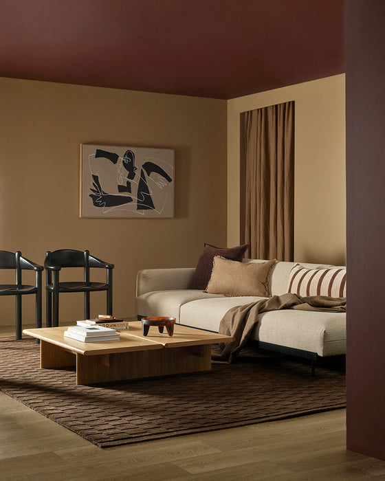 Hugo Floor Rug in Espresso, in a living room with a cream sofa, striped cushions and timber coffee table