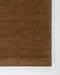 Hugo Floor Rug in Toffee, close-up of a corner showing the edge and wool pile