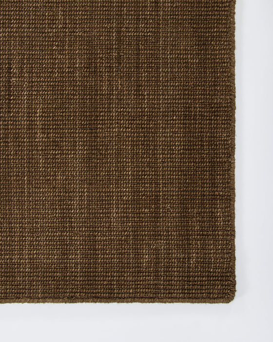 Linden Floor Rug in Ironbark, close-up of a corner showing the edge and wool pile