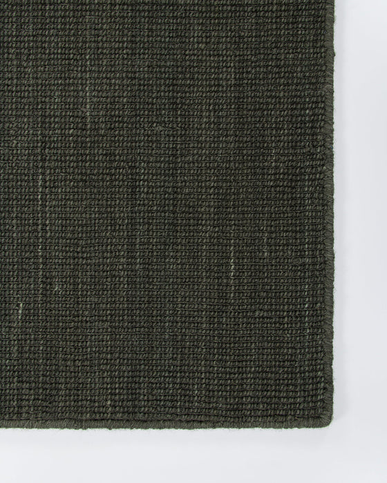 Linden Floor Rug in Petrol, close-up of a corner showing the edge and wool pile