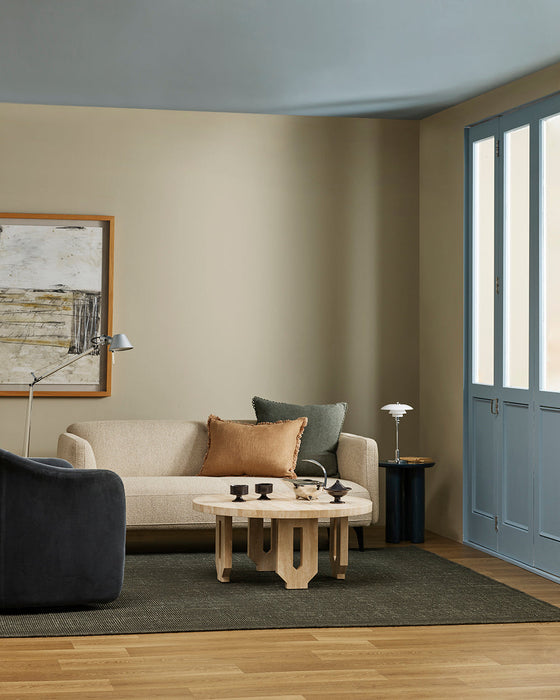 Linden Floor Rug in Petrol, in a living room with a cream sofa, timber coffee table and black armchair