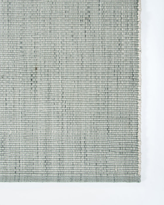 Lonsdale Floor Rug in Eucalyptus, close-up of a corner showing the edge and recycled PET pile