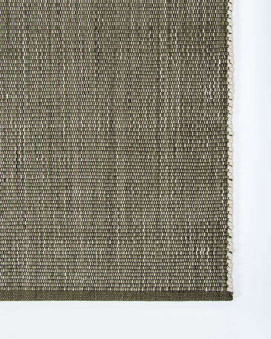 Lonsdale Floor Rug in Olive, close-up of a corner showing the edge and recycled PET pile