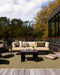 Lonsdale Floor Rug in Olive, on a timber deck with an outdoor sofa and black coffee table