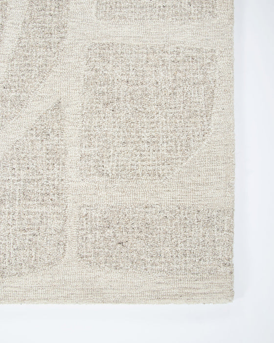 Maya Floor Rug in Oatmeal, close-up of a corner showing the edge and wool pile