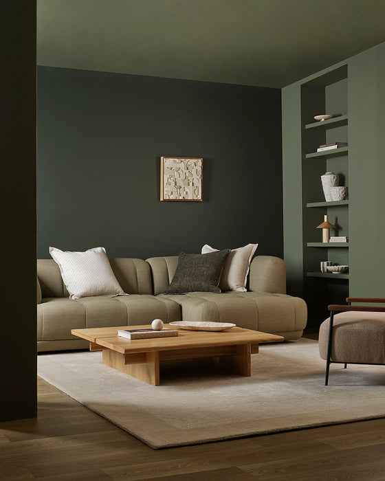 Mayfair Floor Rug in Abalone, in a green living room under a low timber coffee table and curved sofa