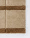 Mesa Floor Rug in Camel, close-up of a corner showing the edge and wool pile
