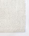 Nebraska Floor Rug in Natural White, close-up of a corner showing the edge and wool and viscose pile