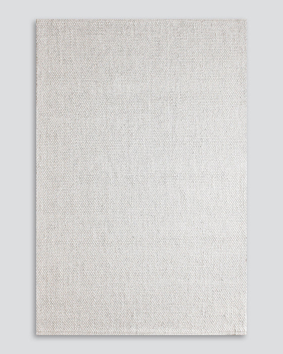 Nebraska Floor Rug in Natural White, the whole rug shown flat on a plain background